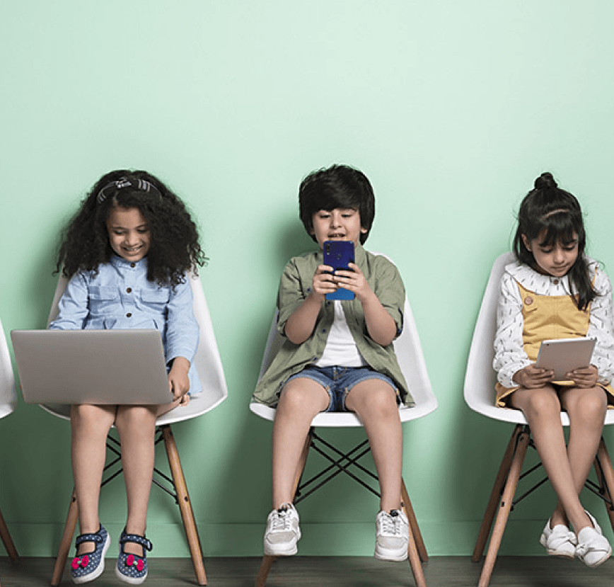 Two children looking at a digital tree with STEAM education icons